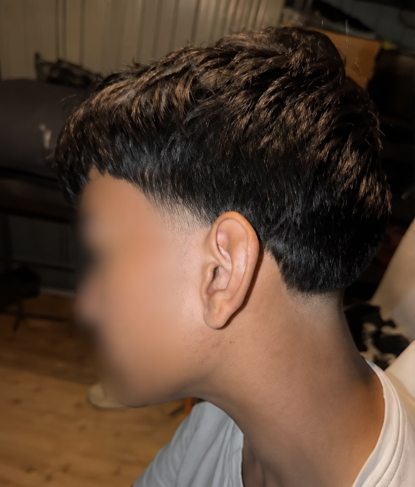 Thick textured top with lightened tips over a clean low taper